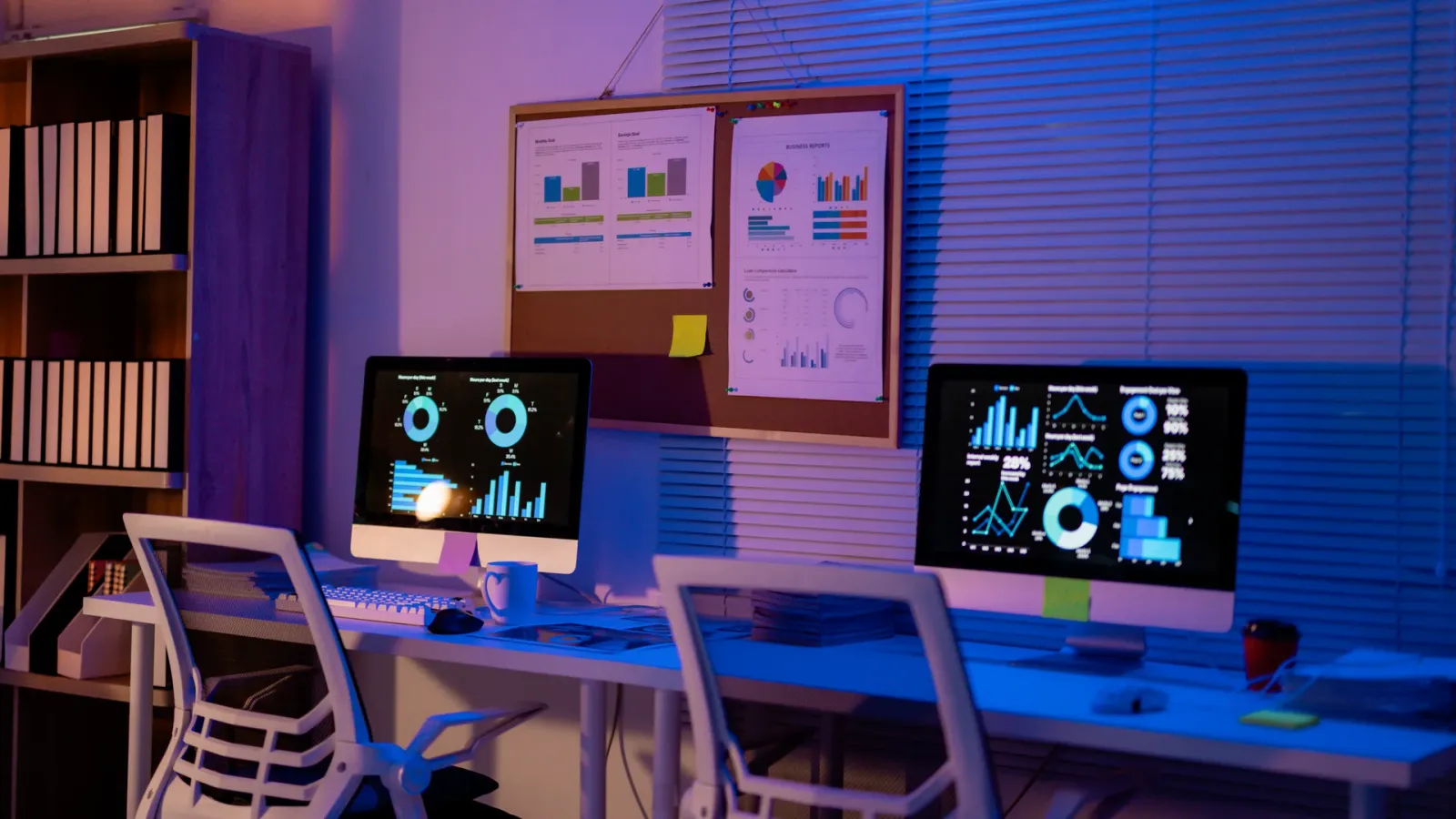 Office with two screens displaying dashboards